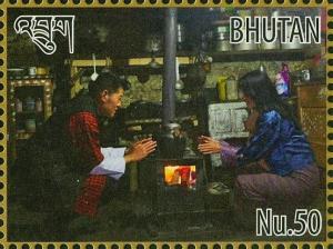 Colnect-4045-918-King-Jigme-and-Queen-Jetsun-near-stove.jpg