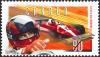 Colnect-588-608-Close-up-of-Gilles-Villeneuve-with-Ferrari-T-3-in-background.jpg