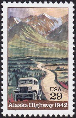 Colnect-5099-493-Truck-on-Alaska-Highway-with-Mountains-in-Background.jpg