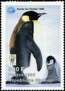 Colnect-5217-124-Adult-penguin-with-sleeping-chick.jpg