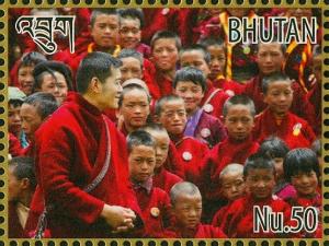 Colnect-4045-917-King-Jigme-Khesar-Namgyel-Wangchuck-and-crowd-of-children.jpg