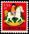 Colnect-3458-193-Child-on-Rocking-Horse-and-Christmas-Tree.jpg