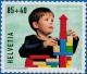 Colnect-5267-438-Child-playing-with-toy-blocks.jpg