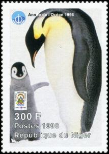 Colnect-5217-137-Adult-penguin-with-raised-chick.jpg