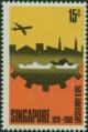 Colnect-444-275-Aircraft-over-silhouette-of-Singapore-docks.jpg