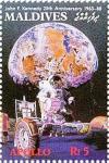 Colnect-4172-533-Earth-and-astronaut-driving-moon-rover.jpg