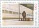 Colnect-174-448-Emigrant-at-Railroad-Station.jpg