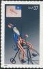 Colnect-202-095-Uncle-Sam-on-Bicycle-with-Liberty-Flag.jpg