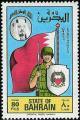 Colnect-1462-637-Soldier-in-front-of-flag-coat-of-arms-of-Bahrain.jpg
