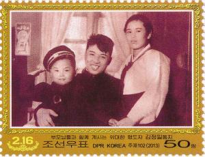 Colnect-3266-397-Kim-Jong-Il-as-a-child-with-his-parents.jpg
