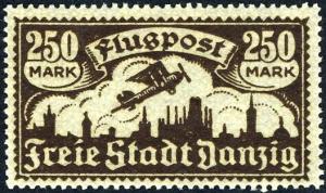 Colnect-1607-910-Airplane-flying-over-the-silhouette-of-the-skyline-of-Danzig.jpg