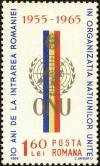 Colnect-4968-121-UNO-badge-in-front-of-Romanian-flag.jpg