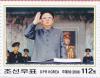 Colnect-3276-453-Kim-with-military-officers-hand-raised.jpg