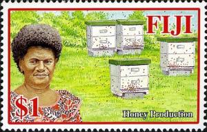 Colnect-769-666-Woman-and-beehives.jpg