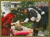 Colnect-4045-922-King-Jigme-and-Queen-Jetsun-looking-at-items-on-table.jpg