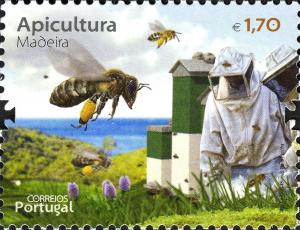Colnect-2710-358-Bees-Apis-sp-on-Returning-to-the-Hive-Beekeeper-with-Pro.jpg