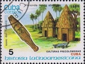 Colnect-1224-489-Tabaco-idol-and-typical-aboriginal-houses-Cuba.jpg
